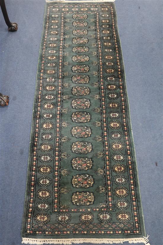 A green Bokhara runner, 183 x 61cm